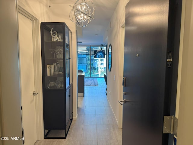 7120 E Kierland Blvd Unit 404, Scottsdale, AZ 85254 - hallway with a chandelier and light tile patterned flooring