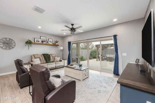 living room featuring hardwood / wood-style floors and ceiling fan