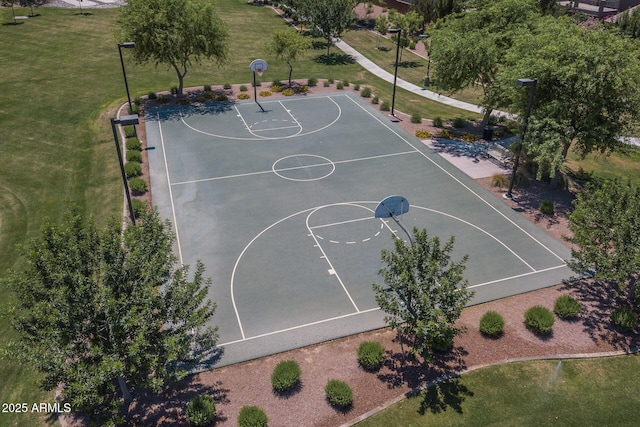 view of sport court with a lawn