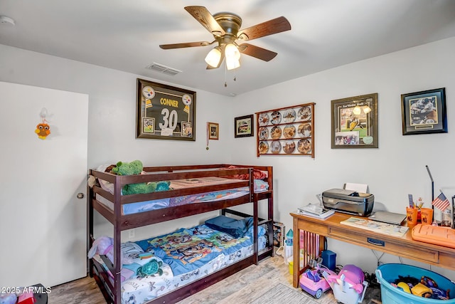 15558 N Ulrich Way, Surprise, AZ 85374 - bedroom featuring wood finished floors, a ceiling fan, and an office area