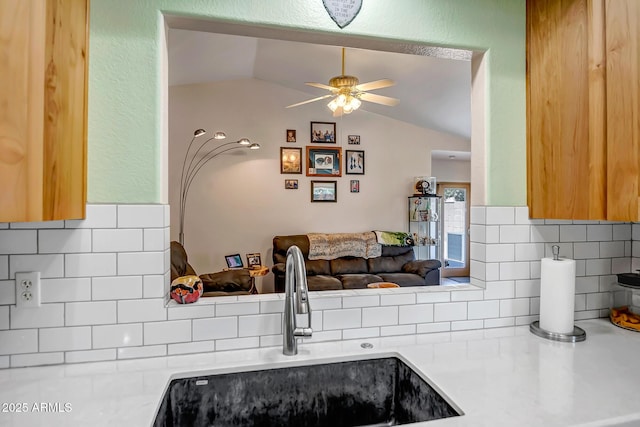 15558 N Ulrich Way, Surprise, AZ 85374 - kitchen featuring a sink, decorative backsplash, light countertops, lofted ceiling, and ceiling fan