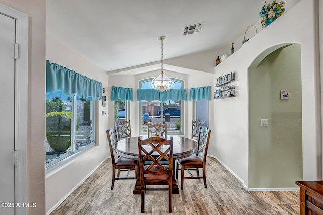 15558 N Ulrich Way, Surprise, AZ 85374 - dining room with plenty of natural light, wood finished floors, lofted ceiling, a chandelier, and baseboards