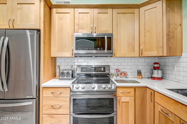 15558 N Ulrich Way, Surprise, AZ 85374 - kitchen featuring stainless steel appliances, light brown cabinets, and backsplash