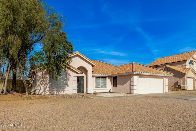 mediterranean / spanish home featuring a garage