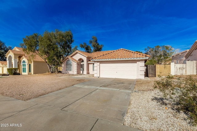 mediterranean / spanish house with a garage