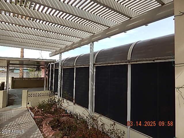 view of patio featuring a sunroom