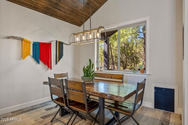 dining room with wooden ceiling, a chandelier, wood finished floors, baseboards, and lofted ceiling