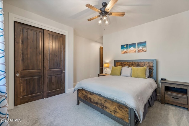 bedroom featuring baseboards, a ceiling fan, a closet, and carpet flooring
