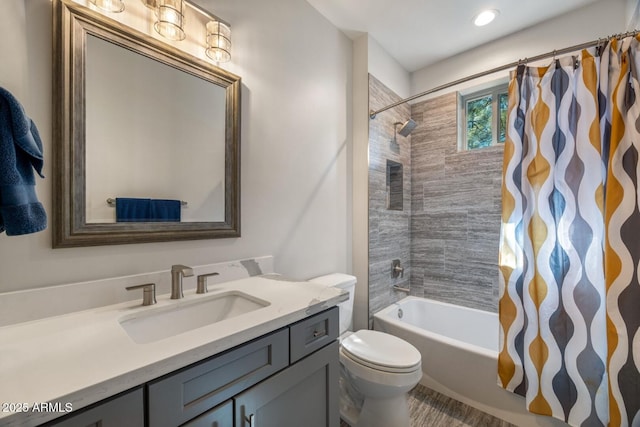 full bathroom featuring shower / bathtub combination with curtain, toilet, and vanity