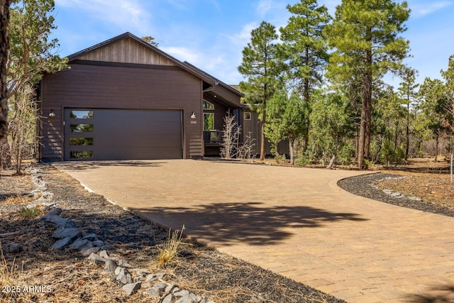 view of front of home with decorative driveway and a garage