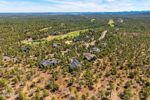 birds eye view of property with a view of trees