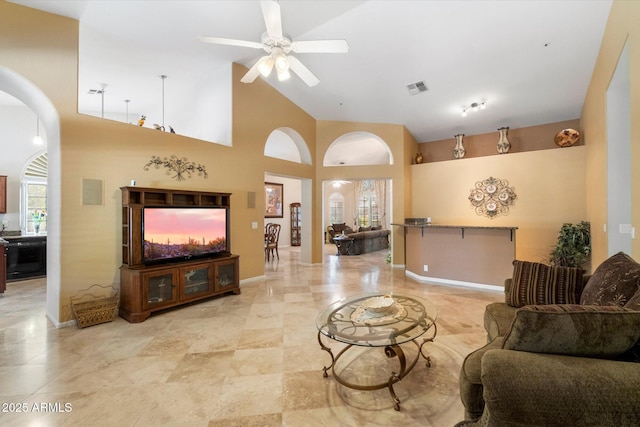 living room featuring plenty of natural light, high vaulted ceiling, and ceiling fan