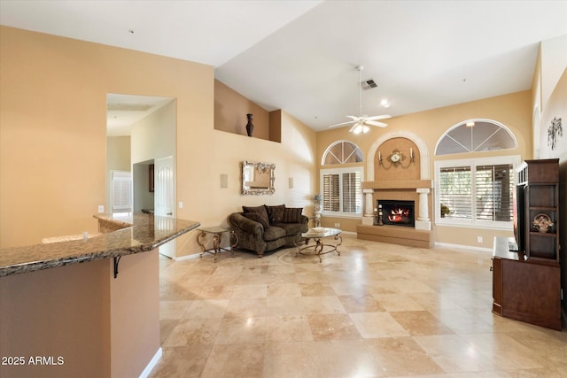 living room with ceiling fan and high vaulted ceiling