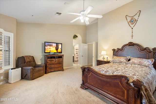 carpeted bedroom with high vaulted ceiling and ceiling fan