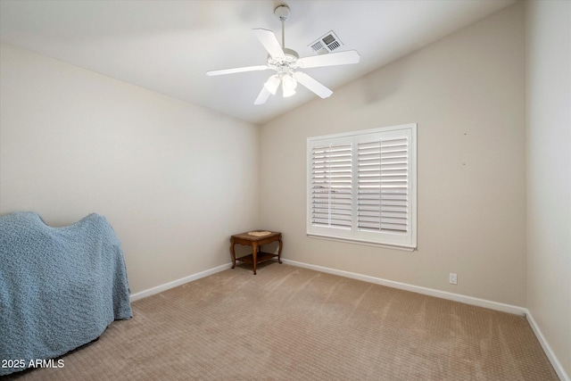 empty room with ceiling fan, light colored carpet, and vaulted ceiling