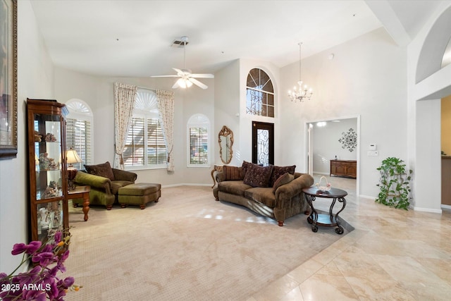 living room featuring ceiling fan with notable chandelier, light colored carpet, and high vaulted ceiling