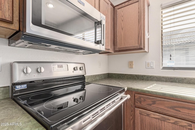 kitchen featuring appliances with stainless steel finishes and a healthy amount of sunlight