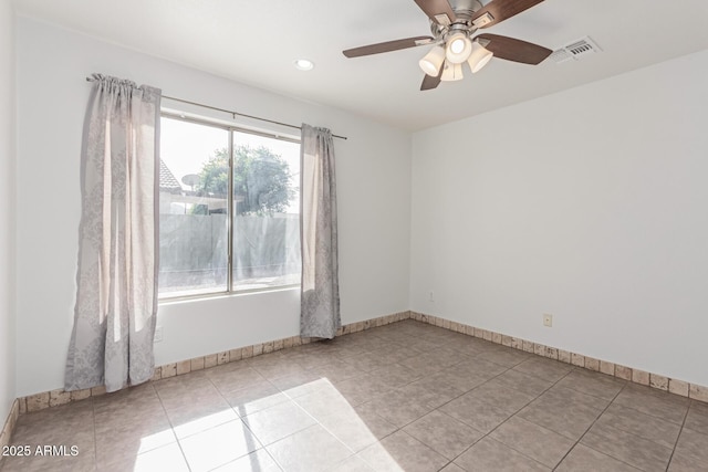 empty room with light tile patterned floors and ceiling fan