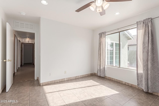 spare room featuring ceiling fan and light tile patterned floors