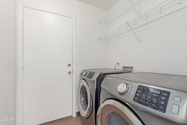 laundry area with tile patterned flooring and washing machine and dryer