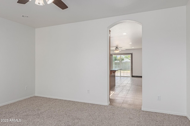 carpeted empty room featuring ceiling fan