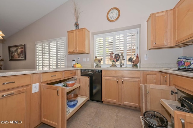 kitchen featuring light brown cabinetry, dishwasher, vaulted ceiling, and a wealth of natural light