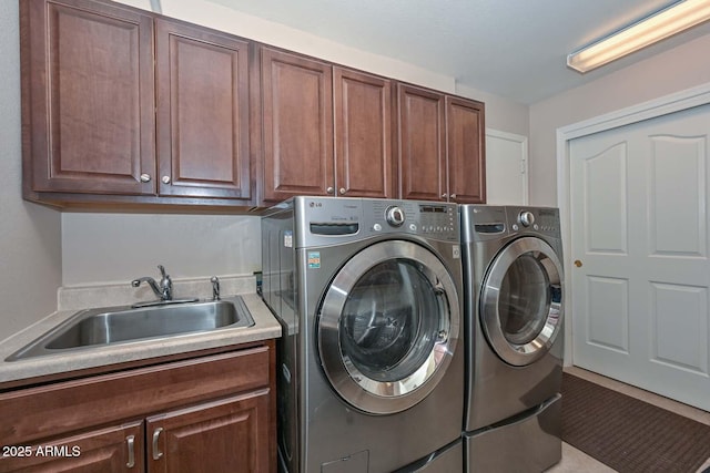 washroom with independent washer and dryer, cabinets, and sink