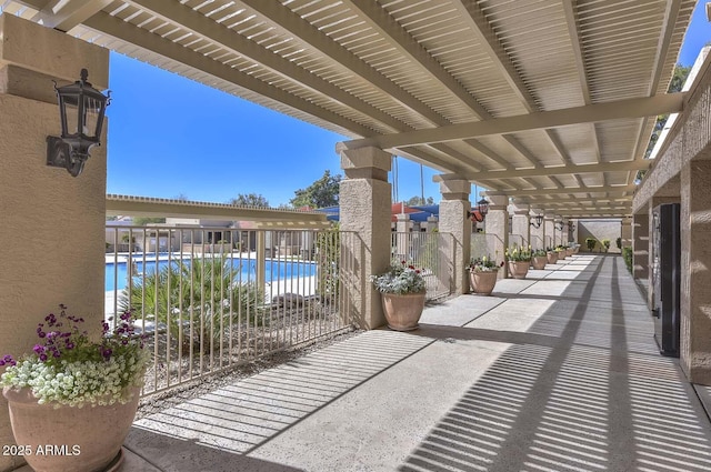 view of patio featuring a community pool and a pergola