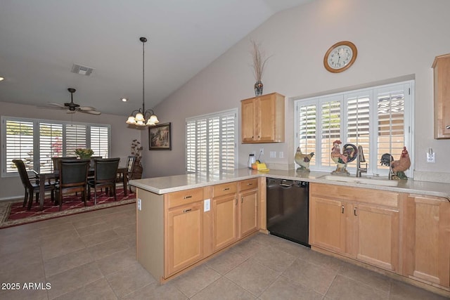 kitchen featuring pendant lighting, black dishwasher, sink, kitchen peninsula, and a healthy amount of sunlight