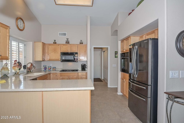 kitchen with sink, black appliances, kitchen peninsula, and light brown cabinets