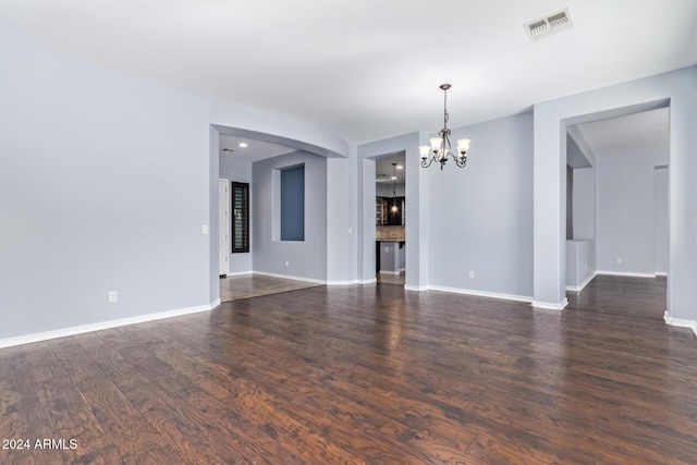 interior space featuring dark hardwood / wood-style flooring and a chandelier