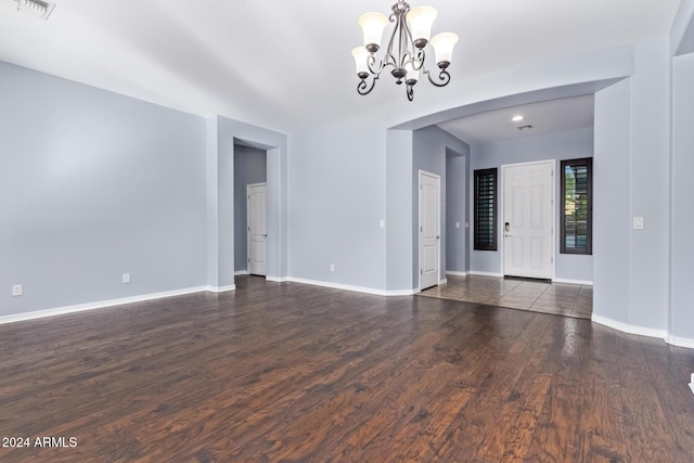 interior space featuring dark hardwood / wood-style floors and a chandelier