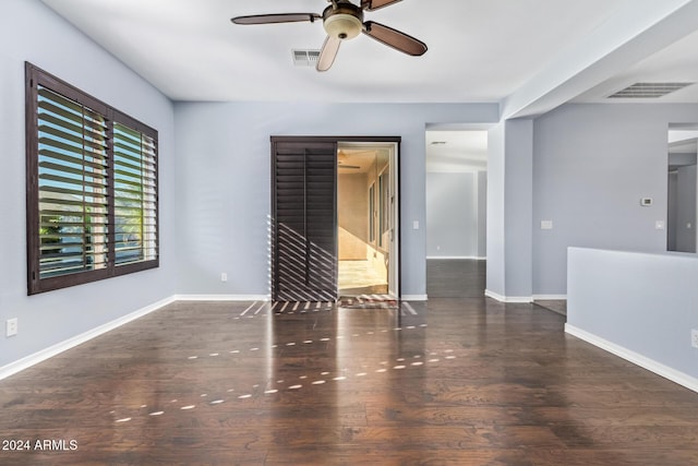 empty room featuring ceiling fan and dark hardwood / wood-style flooring