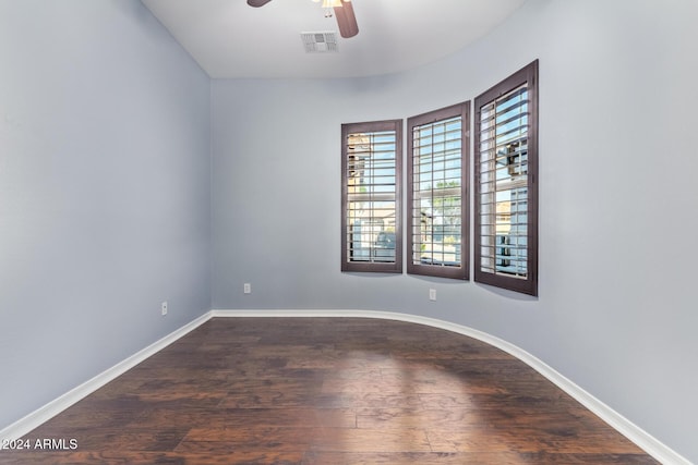 unfurnished room featuring dark hardwood / wood-style floors and ceiling fan