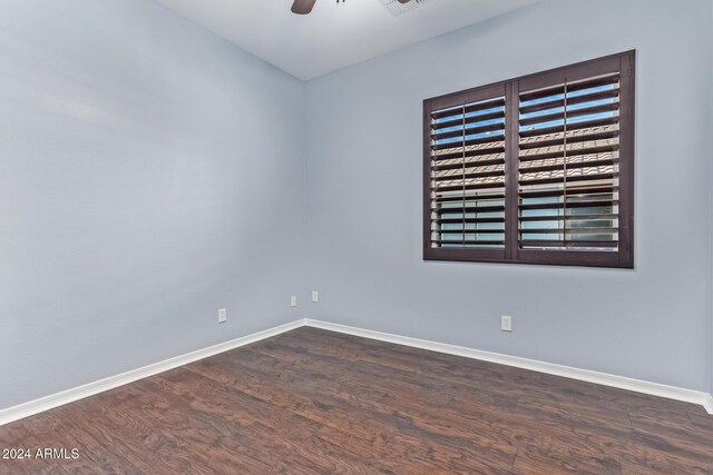 empty room with ceiling fan and dark wood-type flooring