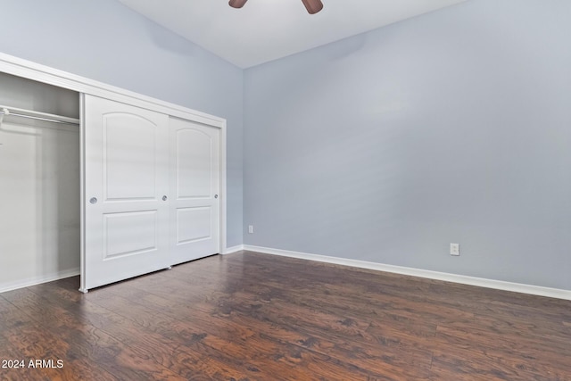 unfurnished bedroom with a closet, ceiling fan, and dark wood-type flooring