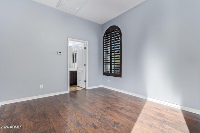 spare room featuring dark wood-type flooring