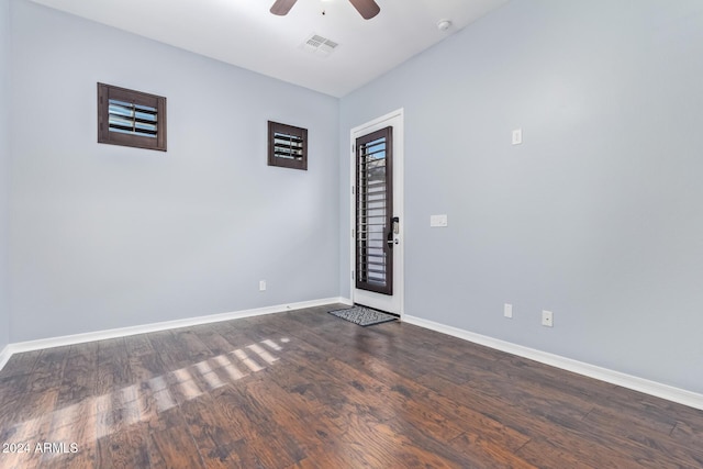 empty room featuring dark hardwood / wood-style flooring and ceiling fan