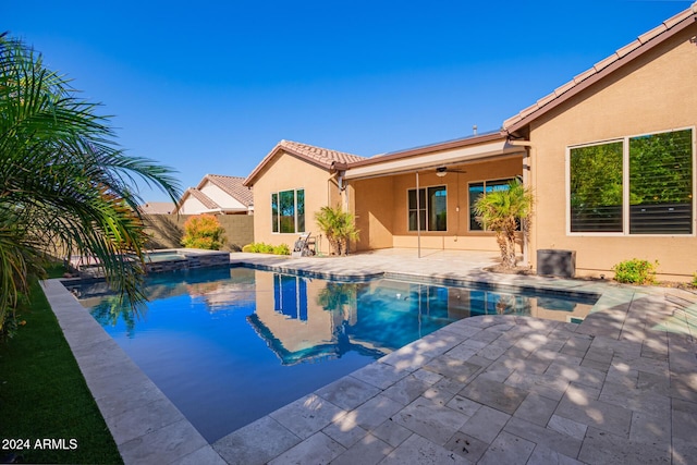 view of swimming pool featuring an in ground hot tub, ceiling fan, and a patio