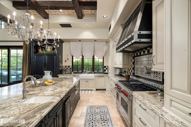 kitchen featuring light stone countertops, sink, wall chimney exhaust hood, and double oven range