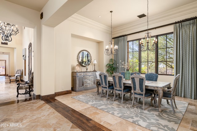 dining area with hardwood / wood-style floors, crown molding, and a notable chandelier