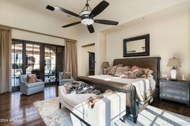 bedroom with french doors, ceiling fan, access to exterior, a towering ceiling, and dark hardwood / wood-style flooring