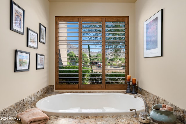 bathroom with a relaxing tiled tub