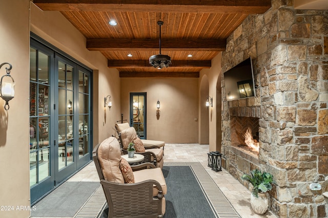 view of patio / terrace featuring an outdoor stone fireplace and french doors