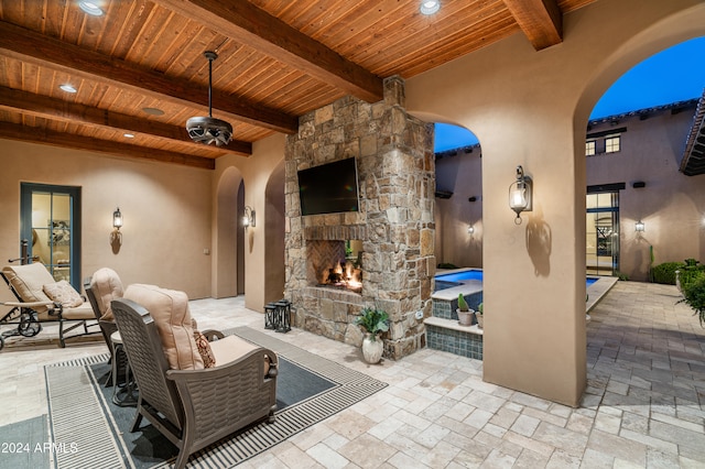 view of patio with an outdoor stone fireplace