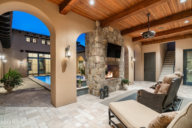 view of patio with an outdoor stone fireplace