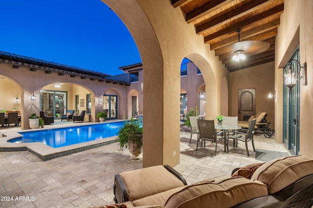 view of swimming pool featuring a patio area, ceiling fan, and an outdoor hangout area