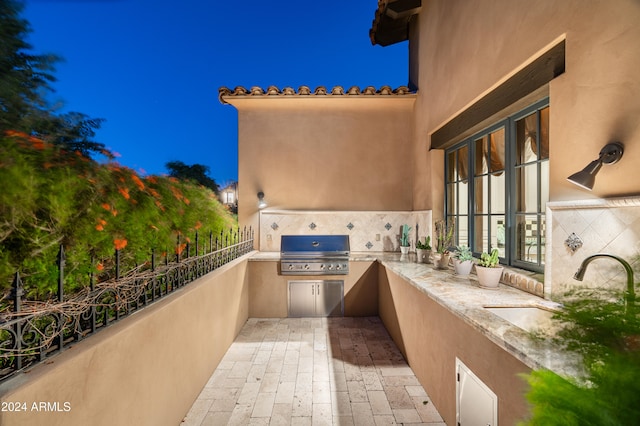 view of patio with grilling area, sink, and area for grilling