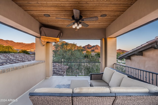 view of patio / terrace featuring a mountain view, a balcony, and ceiling fan