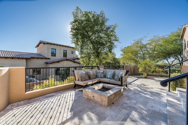 view of patio / terrace with an outdoor living space with a fire pit